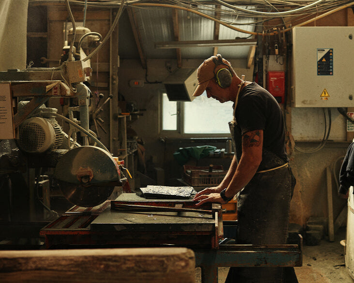 Person working in a workshop with machinery and tools around